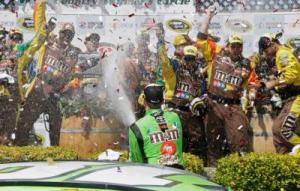 Kyle Busch sprays his crew after winning the NASCAR Sprint Cup Series auto race Sunday, June 28, 2015, in Sonoma, Calif. (AP Photo/Eric Risberg)